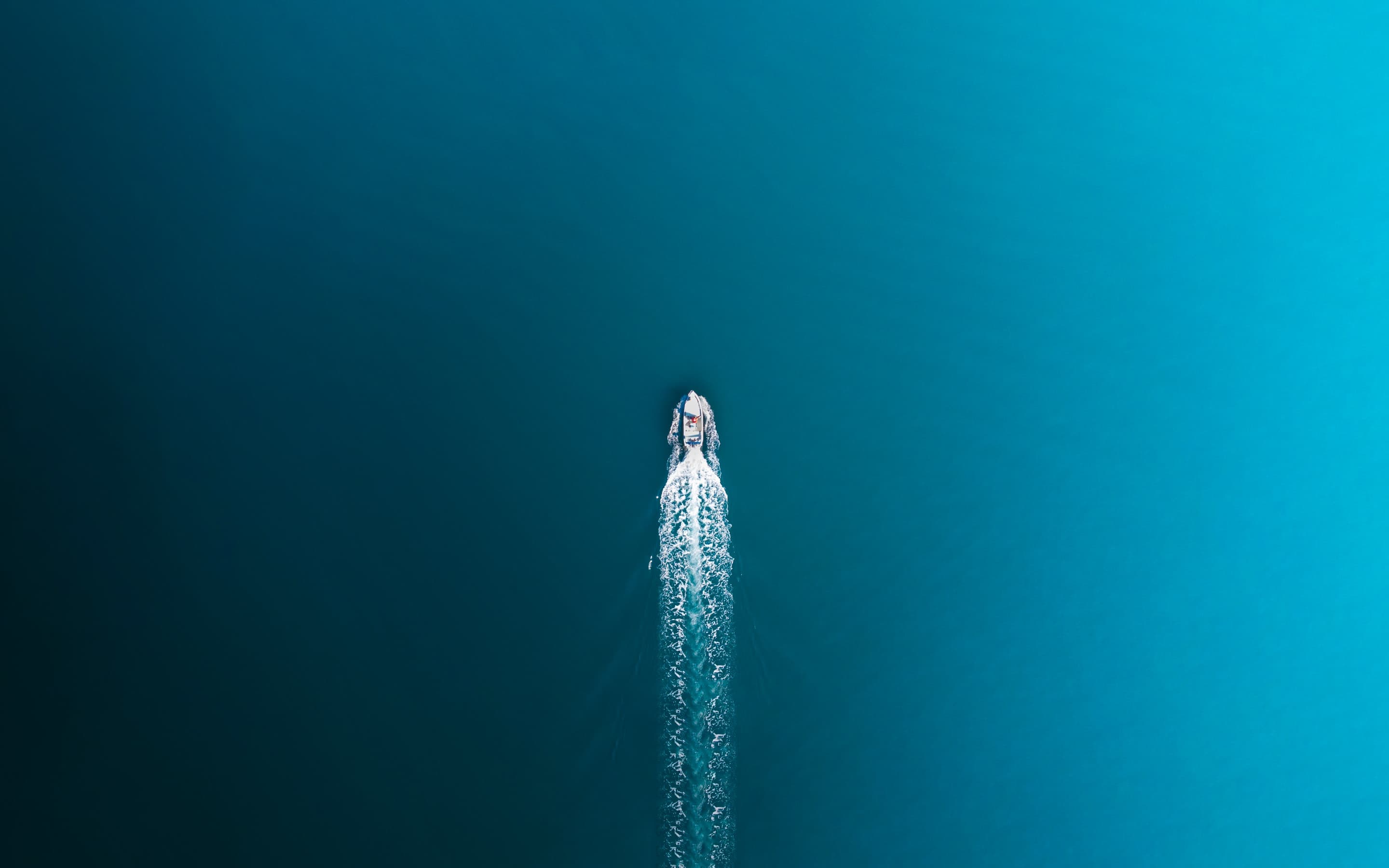 Aerial boat on teal water